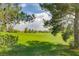 Expansive golf course view framed by lush trees, offering a picturesque landscape perfect for recreation and relaxation at 7760 Pine Warbler Way, North Las Vegas, NV 89084