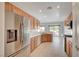 Modern kitchen with stainless steel appliances, light wood cabinets, and ample counter space for cooking at 7760 Pine Warbler Way, North Las Vegas, NV 89084