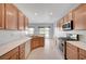 Well-equipped kitchen featuring modern appliances, light wood cabinetry, and a functional layout at 7760 Pine Warbler Way, North Las Vegas, NV 89084