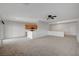Open living room with neutral carpet, ceiling fan, and easy access to the kitchen and entryway at 7760 Pine Warbler Way, North Las Vegas, NV 89084