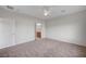 Spacious main bedroom with neutral carpet, ceiling fan, and ensuite bathroom at 7760 Pine Warbler Way, North Las Vegas, NV 89084