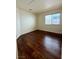 Bedroom featuring hardwood floors and natural light from a window showcases style and comfort at 7821 Desert Bell Ave, Las Vegas, NV 89128