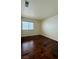 Bedroom featuring hardwood floors and natural light from a window showcases style and comfort at 7821 Desert Bell Ave, Las Vegas, NV 89128