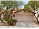 Charming single-story home with a tile roof, desert landscaping, and an attached two-car garage at 7821 Desert Bell Ave, Las Vegas, NV 89128