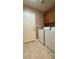 Functional laundry room with tile floor, includes modern washer, dryer and practical storage at 7821 Desert Bell Ave, Las Vegas, NV 89128
