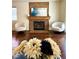 Living room featuring a fireplace, hardwood floors, neutral paint, and cozy seating area at 7821 Desert Bell Ave, Las Vegas, NV 89128