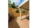 Cozy covered patio with brick pavers and a privacy wall creates a serene outdoor living space at 7821 Desert Bell Ave, Las Vegas, NV 89128