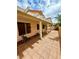 View of a tiled covered patio featuring multiple windows overlooking the backyard at 7821 Desert Bell Ave, Las Vegas, NV 89128