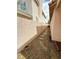Side yard featuring a stone pathway between two stucco walls at 7821 Desert Bell Ave, Las Vegas, NV 89128