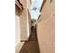 Narrow passageway with paving stones between two buildings, creating a private walkway at 7821 Desert Bell Ave, Las Vegas, NV 89128