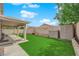 Backyard featuring a covered patio, artificial grass, storage shed and block wall at 8009 Tailwind Ave, Las Vegas, NV 89131