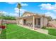 Outdoor living with covered patio, lush green lawn, and plenty of space to relax or entertain at 8009 Tailwind Ave, Las Vegas, NV 89131