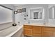 Bright bathroom with a double sink, illuminated mirror, and a separate soaking tub at 8009 Tailwind Ave, Las Vegas, NV 89131