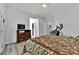 Bedroom featuring a dresser with TV, elliptical machine, and wood look floors at 8009 Tailwind Ave, Las Vegas, NV 89131
