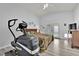 Bright bedroom featuring an elliptical machine, ceiling fan, and wood look floors at 8009 Tailwind Ave, Las Vegas, NV 89131