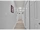 Bright hallway with hardwood floors and multiple closet doors at 8009 Tailwind Ave, Las Vegas, NV 89131