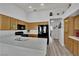 Functional kitchen with black appliances, light wood cabinets, and tile countertops at 8009 Tailwind Ave, Las Vegas, NV 89131