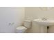 A minimalist bathroom featuring a toilet, sink, and neutral color palette at 8249 Jo Marcy Dr, Las Vegas, NV 89131