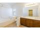 Bathroom featuring a large tub, double sinks, and a sliding door closet, offering lots of space at 8249 Jo Marcy Dr, Las Vegas, NV 89131