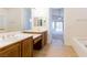 Primary bath showcasing double sink vanity, tile floors, and a door leading to the bedroom at 8249 Jo Marcy Dr, Las Vegas, NV 89131