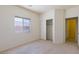 Bright bedroom featuring a large window, closet, and neutral color palette creating a calm atmosphere at 8249 Jo Marcy Dr, Las Vegas, NV 89131