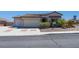 Charming single-story home with a three-car garage, desert landscaping, and a tile roof at 8249 Jo Marcy Dr, Las Vegas, NV 89131