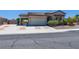Charming exterior with tile roof, two-car garage, porte-cochere, and low maintenance landscaping at 8249 Jo Marcy Dr, Las Vegas, NV 89131