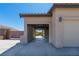 An oversized porte-cochere leads to a two-car garage, which also has a pass-through to the backyard at 8249 Jo Marcy Dr, Las Vegas, NV 89131