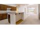 Open kitchen with wooden cabinets, a breakfast bar, and views into the living area at 8249 Jo Marcy Dr, Las Vegas, NV 89131