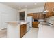 Functional kitchen with wood cabinets, white appliances, and a breakfast bar at 8249 Jo Marcy Dr, Las Vegas, NV 89131
