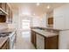 Open kitchen with wooden cabinets, white appliances, and a view to the backyard at 8249 Jo Marcy Dr, Las Vegas, NV 89131