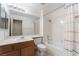 Bright bathroom with a single sink vanity, framed mirror, and shower-tub combination at 8277 Mount Nido Dr, Las Vegas, NV 89147