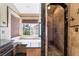 Luxurious bathroom featuring a soaking tub, walk-in shower, and a window overlooking the backyard at 8277 Mount Nido Dr, Las Vegas, NV 89147
