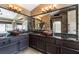 Primary bathroom featuring granite countertops, dual sinks, and expansive mirror creating an elegant and functional space at 8277 Mount Nido Dr, Las Vegas, NV 89147
