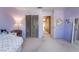 Comfortable bedroom with a closet, light walls, carpet and a plush chair at 8277 Mount Nido Dr, Las Vegas, NV 89147