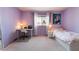 Cozy bedroom featuring a study desk, a bed and ample natural light from the window at 8277 Mount Nido Dr, Las Vegas, NV 89147