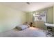 Carpeted bedroom featuring a twin bed, a study desk, and a window for natural light at 8277 Mount Nido Dr, Las Vegas, NV 89147