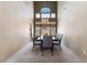 Elegant dining room with a modern chandelier, large windows and seating for eight at 8277 Mount Nido Dr, Las Vegas, NV 89147