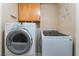 Modern laundry room with updated washer and dryer and cabinets for storage at 8277 Mount Nido Dr, Las Vegas, NV 89147