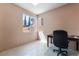 The office features a well-lit workspace with large window; neutral walls and tile floors at 8277 Mount Nido Dr, Las Vegas, NV 89147
