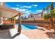 Inviting backyard pool with hot tub, covered patio, and poolside seating, perfect for outdoor relaxation and entertaining at 8277 Mount Nido Dr, Las Vegas, NV 89147