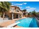 Resort-style backyard featuring a refreshing pool, diving board, hot tub, and covered patio, ideal for outdoor living at 8277 Mount Nido Dr, Las Vegas, NV 89147