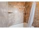 Luxurious tile shower and tub combination complete with a rainfall shower head at 8277 Mount Nido Dr, Las Vegas, NV 89147