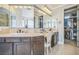 A luxurious bathroom boasting dual sinks, granite countertops, and a decorative chair at 8537 Eureka Heights Ct, Las Vegas, NV 89178