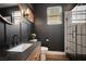 Modern bathroom with sleek vanity, black accents, and a stylish glass-enclosed shower at 8537 Eureka Heights Ct, Las Vegas, NV 89178