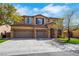 Stunning two-story home with a three-car garage, stone accents, and a well-maintained front lawn at 8537 Eureka Heights Ct, Las Vegas, NV 89178