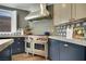 Gourmet kitchen featuring stainless steel Wolf range, custom cabinetry, and stylish backsplash at 8537 Eureka Heights Ct, Las Vegas, NV 89178