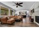 Spacious living room with a cozy sectional couch, fireplace, and view into the kitchen at 8537 Eureka Heights Ct, Las Vegas, NV 89178