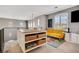 Cozy loft area featuring a yellow sofa, entertainment center, and sunny windows at 8537 Eureka Heights Ct, Las Vegas, NV 89178