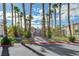 Gated entry to the community lined with palm trees and well-maintained landscaping at 8725 W Flamingo Rd # 240, Las Vegas, NV 89147
